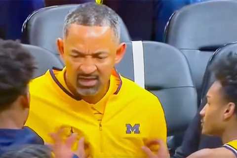 Michigan coach Juwan Howard restrained by players in late-game meltdown