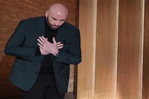 John Travolta breaks down in a puddle of tears on Oscars stage as he introduces Olivia..