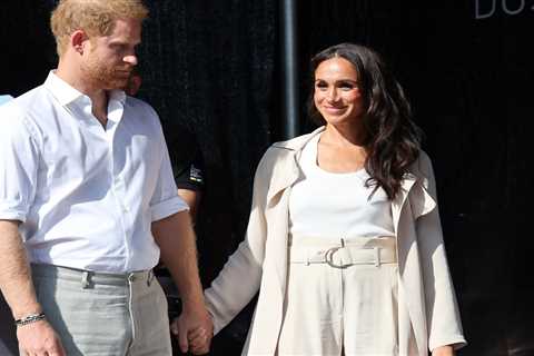 Meghan Markle and Prince Harry hold hands as they appear for last day of Invictus Games