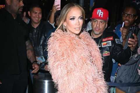 Jennifer Lopez Wore a Peach $835 “The New Arrival” Dress with a Feather Bolero and FEMME LA Heels..