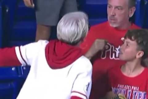 Angry Phillies fan slammed for snatching home run ball from young boy after she chased down his dad